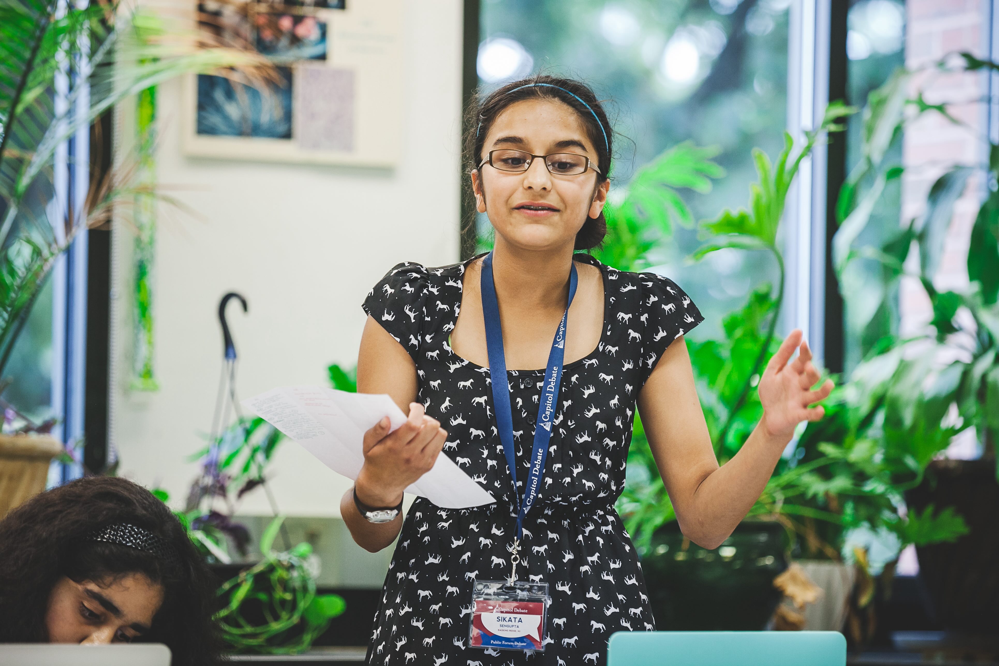 Student confidently presenting during debate