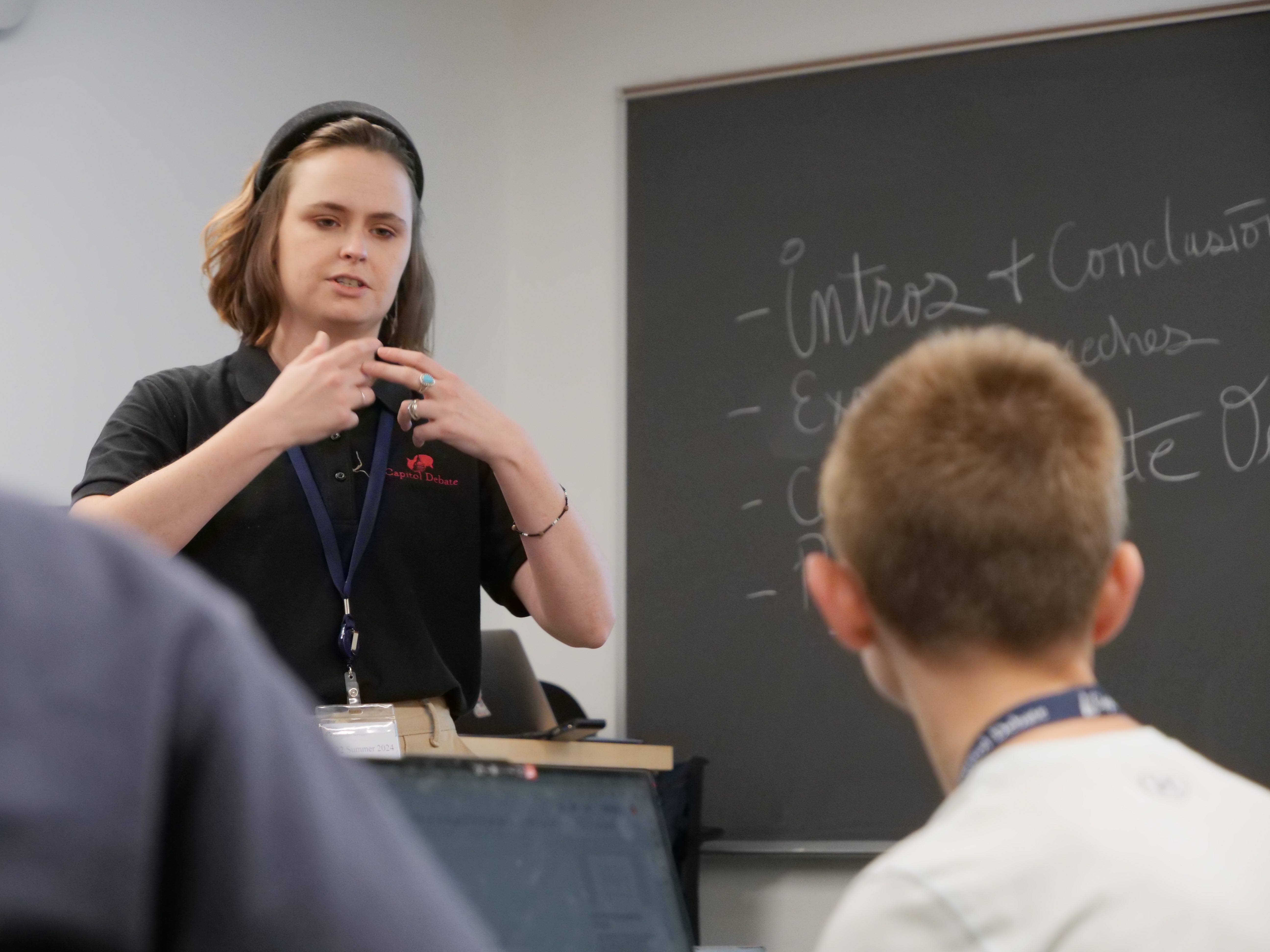 Teacher explaining debate techniques